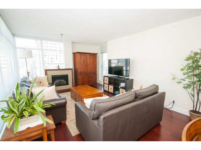 Furnished living room with hardwood floors, city view, and modern decor. - 1606-158 West 13th Street, North Vancouver