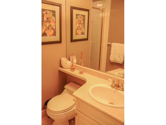 Bright bathroom with white countertops and framed artwork. - 3199 Pt. Grey Road, Vancouver West Side