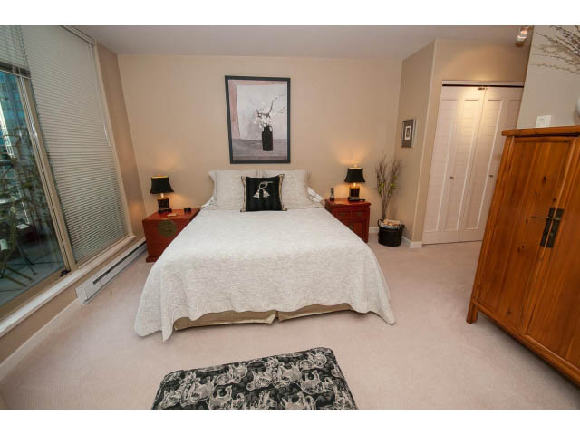 Spacious bedroom with large bed, wooden furniture, and city view. - 1404 - 819 Hamilton Street, Vancouver Downtown