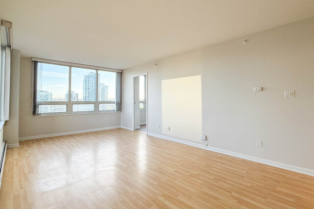 The living room with large windows onto the Yaletown towers and a door to the den - 15B-199 Drake Street, Vancouver Downtown
