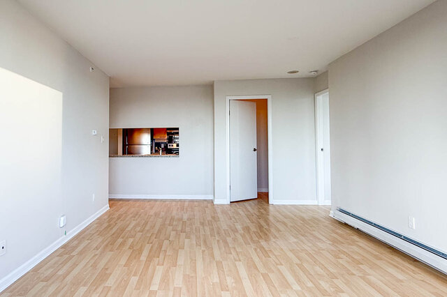 The dining area beside the kitchen pass-through and the hall to the bedrooms - 15B-199 Drake Street, Vancouver Downtown
