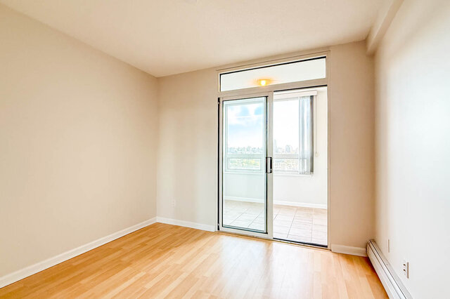 A bedroom with sliding glass doors opening to the den and its windows - 15B-199 Drake Street, Vancouver Downtown