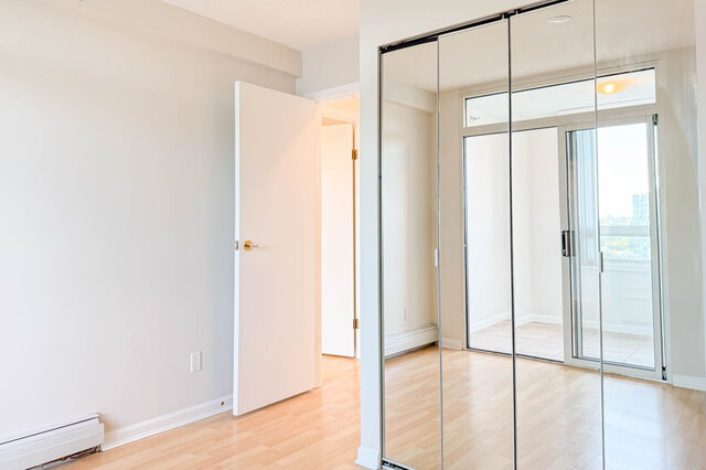 The bedroom's mirrored closet reflecting the den doors - 15B-199 Drake Street, Vancouver Downtown