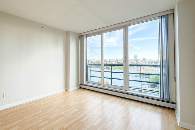 The primary bedroom's floor-to-ceiling windows looking over the balcony to False Creek and the marina - 15B-199 Drake Street, Vancouver Downtown