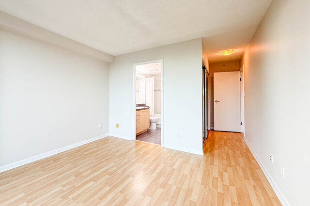 The primary bedroom beside the ensuite and a mirrored closet - 15B-199 Drake Street, Vancouver Downtown