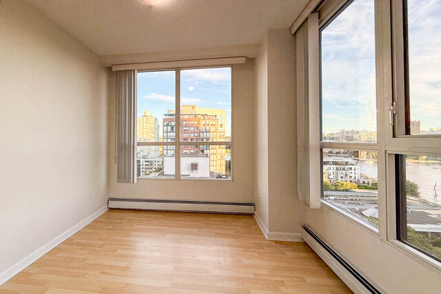 A corner bedroom with windows on two sides, looking over the city and down to False Creek - 15B-199 Drake Street, Vancouver Downtown