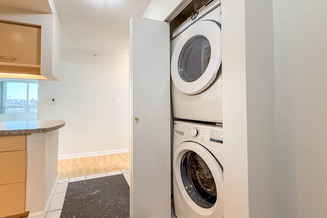 A stacked LG washer and dryer in a closet by the kitchen - 15B-199 Drake Street, Vancouver Downtown