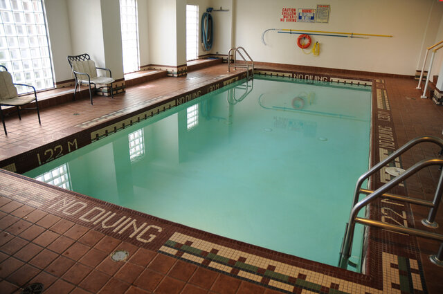 The building's shared indoor pool with a mosaic tile border and glass block windows - 15B-199 Drake Street, Vancouver Downtown
