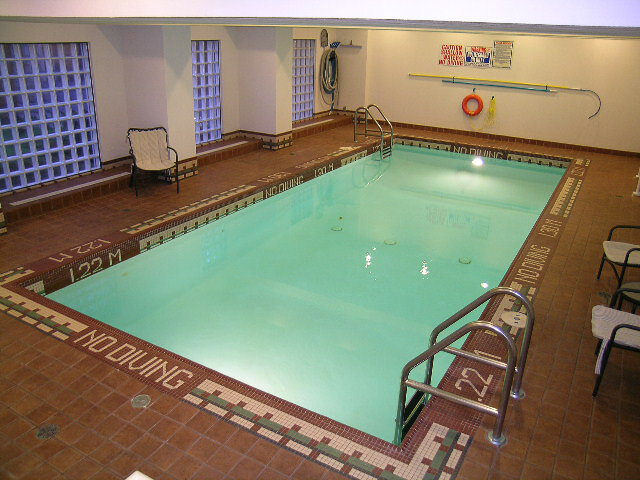 The indoor pool with chairs along the side - 15B-199 Drake Street, Vancouver Downtown