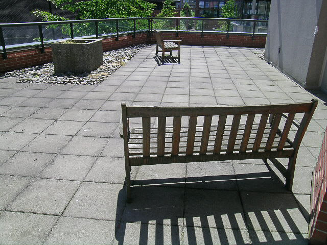 The building's shared patio with benches and planters - 15B-199 Drake Street, Vancouver Downtown