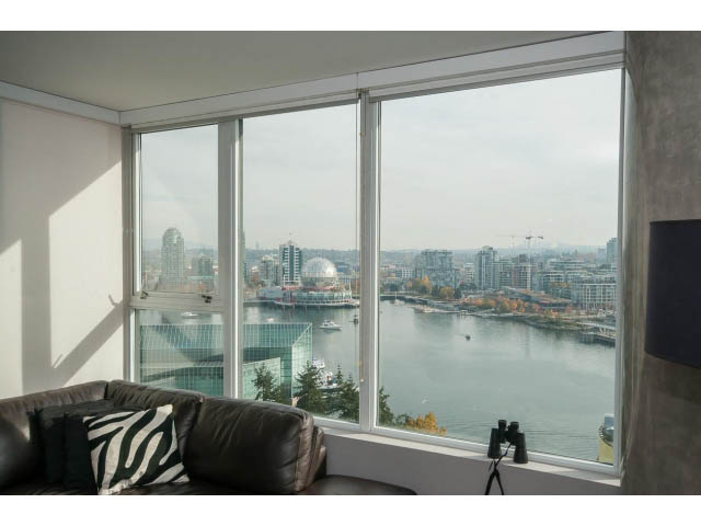 Furnished living room with a stunning city view and large windows. - 2203 - 33 Smithe Mews, Vancouver Downtown