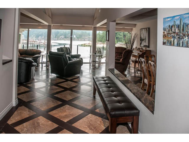 Spacious living room with hardwood floors, city view, and comfortable seating. - 4541 Strathcona Road, North Vancouver