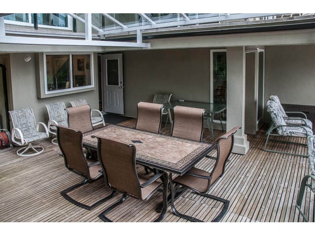 Furnished patio with wooden flooring and outdoor furniture. - 4541 Strathcona Road, North Vancouver