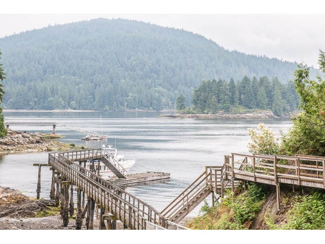 Furnished deck overlooking serene water and forested hills. - 4541 Strathcona Road, North Vancouver