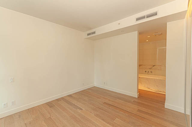 Bright living room with hardwood floors and built-in shelving. - 202 - 1409 W Pender St, Vancouver Downtown