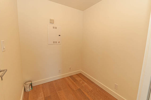Den with hardwood floors and a white wall, clean and ready for furnishings. - 202 - 1409 W Pender St, Vancouver Downtown