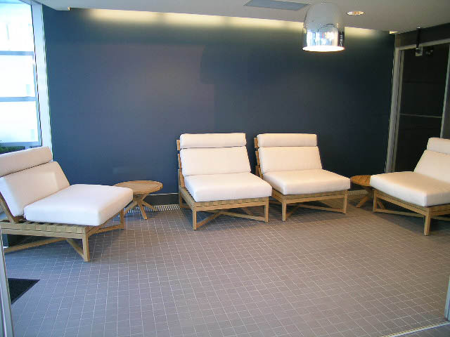 Furnished living room with modern lounge chairs and dark walls. - 202 - 1409 W Pender St, Vancouver Downtown