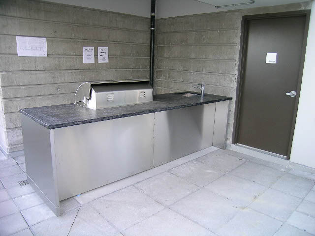 Bright kitchen with stainless steel counters and sink, tiled floor. - 202 - 1409 W Pender St, Vancouver Downtown