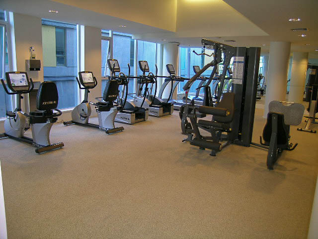 Fitness room with cardio equipment and large windows. - 202 - 1409 W Pender St, Vancouver Downtown