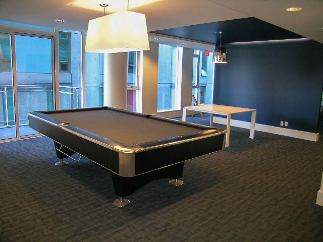 Furnished living room with modern pool table, city view, and contemporary lighting. - 202 - 1409 W Pender St, Vancouver Downtown