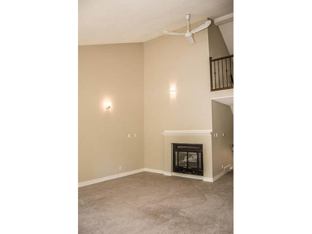 Living room with fireplace, carpeted floor, and ceiling fan. - 2039 McLallen Court, North Vancouver