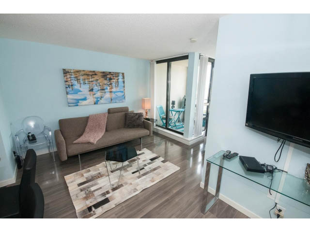 Furnished living room with hardwood floors, modern decor, and a glass coffee table. - 2201 - 938 Smithe Street, Vancouver Downtown