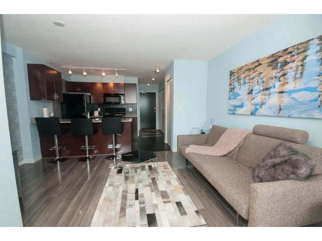 Furnished living room with modern decor, hardwood floors, and a large abstract wall art piece. - 2201 - 938 Smithe Street, Vancouver Downtown