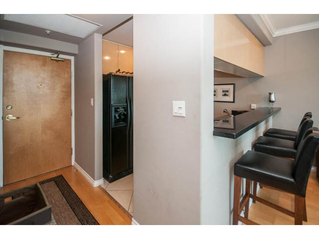 Bright kitchen with black countertops and hardwood floors. - 3602 - 1111 W Pender, Vancouver Downtown