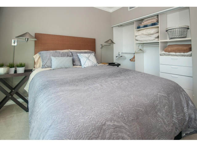 Furnished bedroom with neatly made bed, soft lighting, and built-in closet. - 3602 - 1111 W Pender, Vancouver Downtown