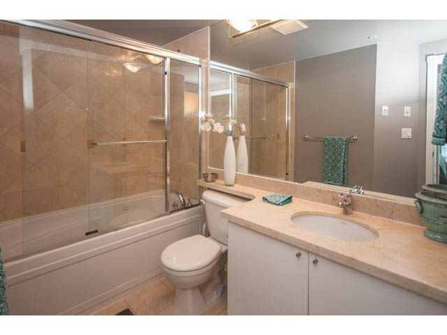 Furnished 1-bedroom condo bathroom with marble countertops and a glass shower. - 3602 - 1111 W Pender, Vancouver Downtown