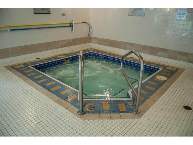 Furnished bathroom with tiled walls and floor, handrails for safety. - 3602 - 1111 W Pender, Vancouver Downtown