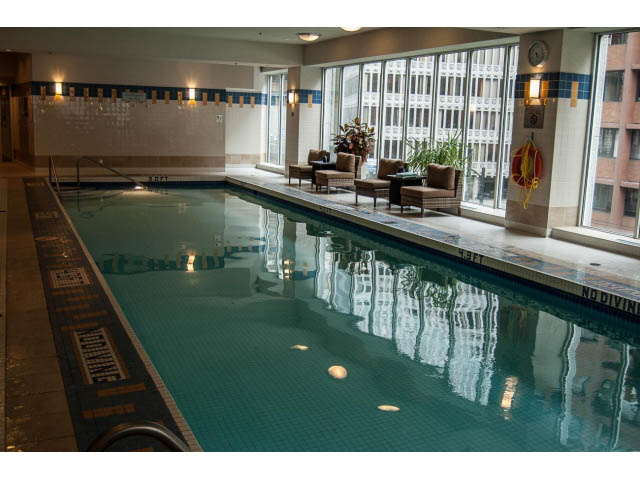 Spacious living room with large windows, city view, and cozy seating area. - 3602 - 1111 W Pender, Vancouver Downtown