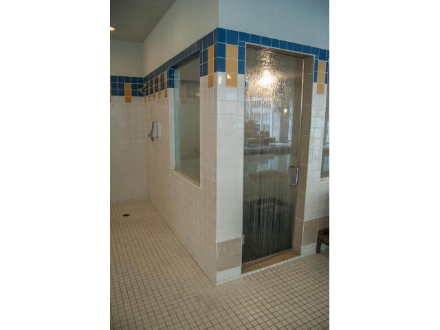 Furnished bathroom with glass shower and blue tile accents. - 3602 - 1111 W Pender, Vancouver Downtown