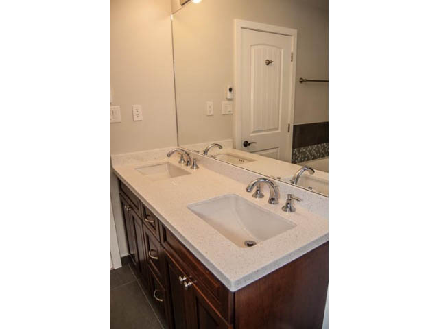 Shared bathroom with granite countertops and dark wood cabinets. - 2269 East 40th Ave, Vancouver East Side