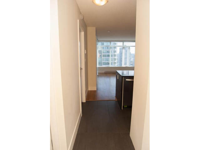 Bright hallway leading to a cozy den with hardwood floors and a city view. - 2306 - 888 Homer Street, Vancouver Downtown