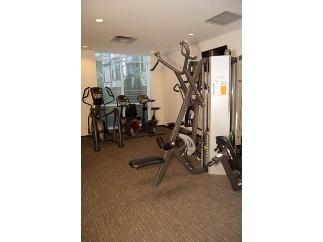 Bright and spacious fitness room with cardio equipment and large windows. - 2306 - 888 Homer Street, Vancouver Downtown