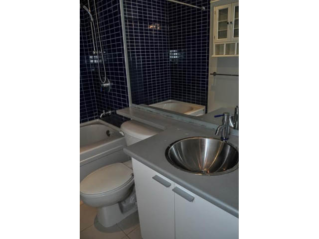 Bright bathroom with dark blue tiles and modern fixtures. - 138 Dunsmuir Street, Vancouver Downtown