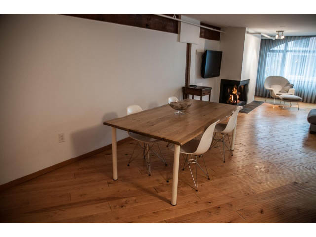 Modern open-concept living space with wooden floors and a fireplace. - 5-4 - 550 Beatty Street, Vancouver Downtown