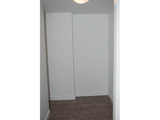 Bright hallway with white closet doors and hardwood floors. - 906 - 110 Switchmen St, Vancouver East Side