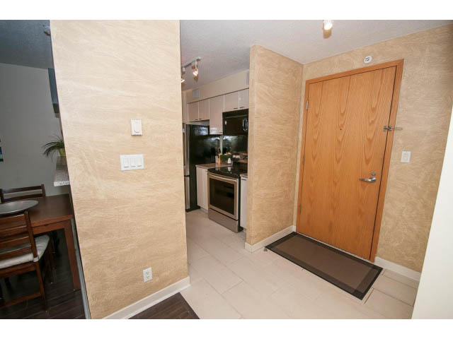 Bright kitchen with stainless steel appliances and light wood cabinets. - 507 - 1200 West Georgia Street, Vancouver Downtown