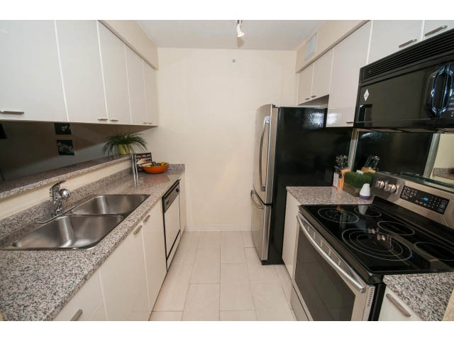 Bright kitchen with granite countertops and stainless steel appliances. - 507 - 1200 West Georgia Street, Vancouver Downtown