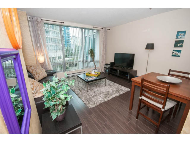 Bright living room with hardwood floors, city view, and modern furnishings. - 507 - 1200 West Georgia Street, Vancouver Downtown
