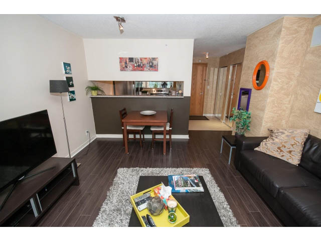 Furnished living room with hardwood floors, modern decor, and a cozy corner setup. - 507 - 1200 West Georgia Street, Vancouver Downtown