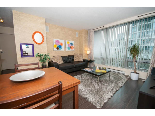 Furnished dining area with hardwood floors, city view, and modern decor. - 507 - 1200 West Georgia Street, Vancouver Downtown