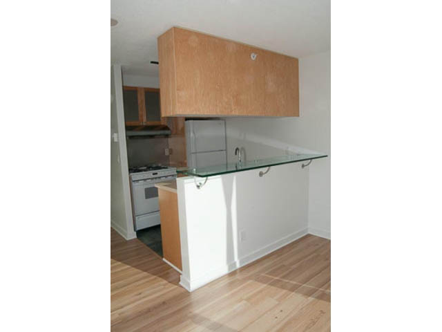 Bright kitchen with light wood cabinets, white countertops, and hardwood floors. - 1406 - 1003 Burnaby Street, Vancouver Downtown