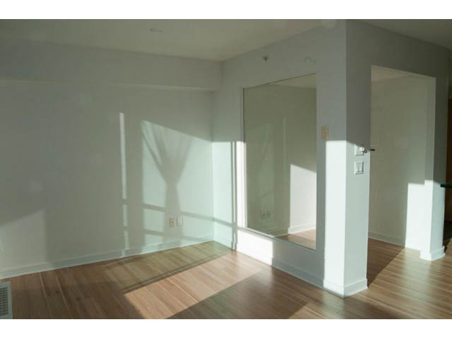 Bright living room with hardwood floors and large windows, letting in natural light. - 1406 - 1003 Burnaby Street, Vancouver Downtown