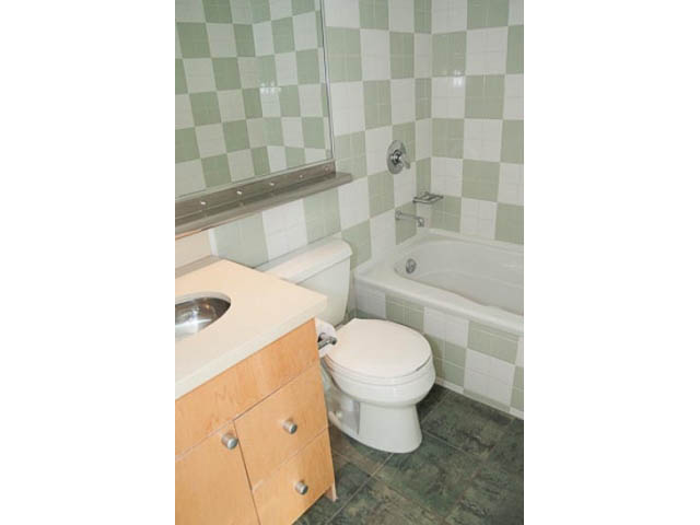 Furnished bathroom with checkered green tiles and wooden vanity. - 1406 - 1003 Burnaby Street, Vancouver Downtown