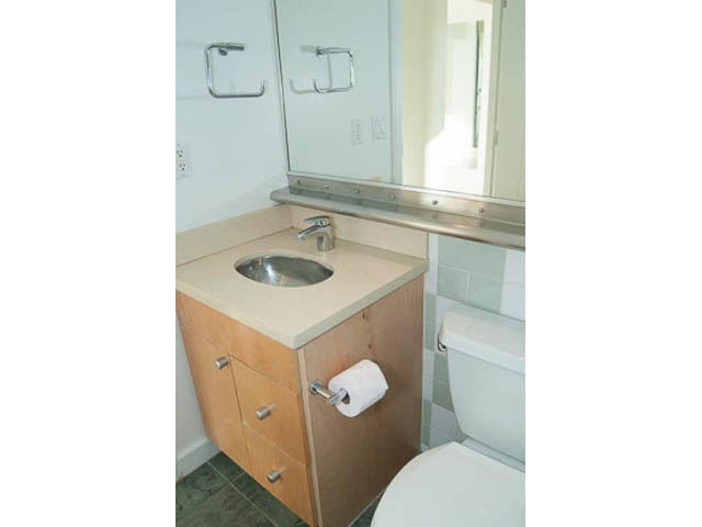 Bright bathroom with wooden cabinets and a modern sink. - 1406 - 1003 Burnaby Street, Vancouver Downtown