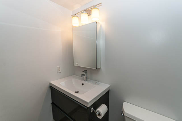 Bright bathroom with white countertop and modern lighting fixture. - 505 - 822 Homer Street, Vancouver Downtown