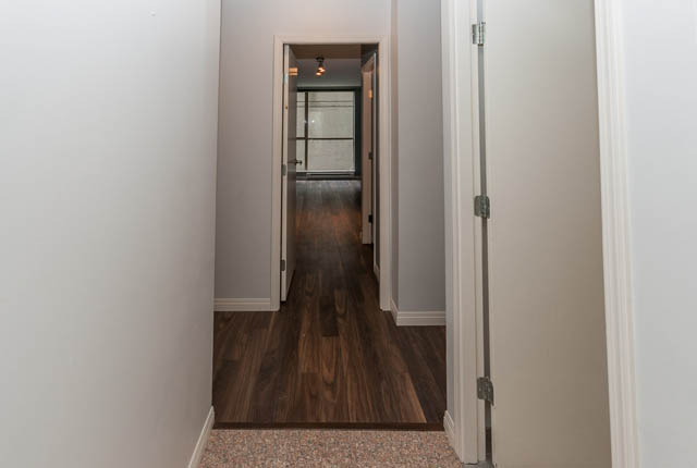 Furnished hallway leading to a room with hardwood floors and a door to another space. - 505 - 822 Homer Street, Vancouver Downtown